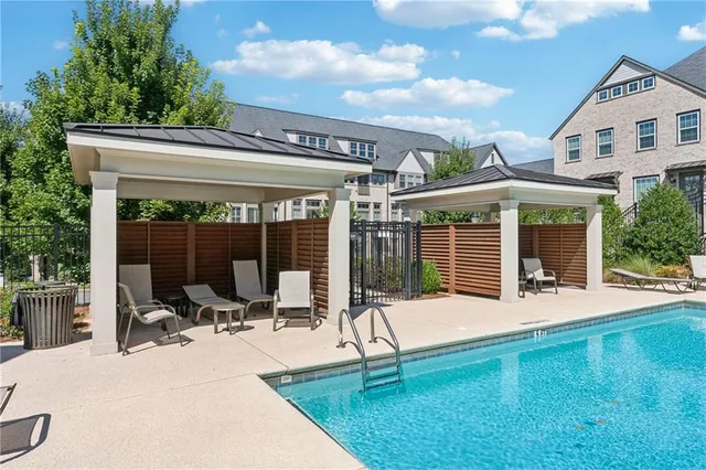 a patio with a table and chairs and potted plants