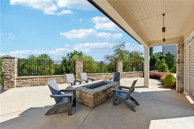 a living room with patio furniture and a potted plants