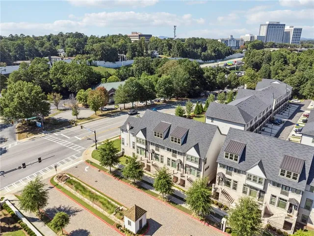 an aerial view of multiple houses with yard