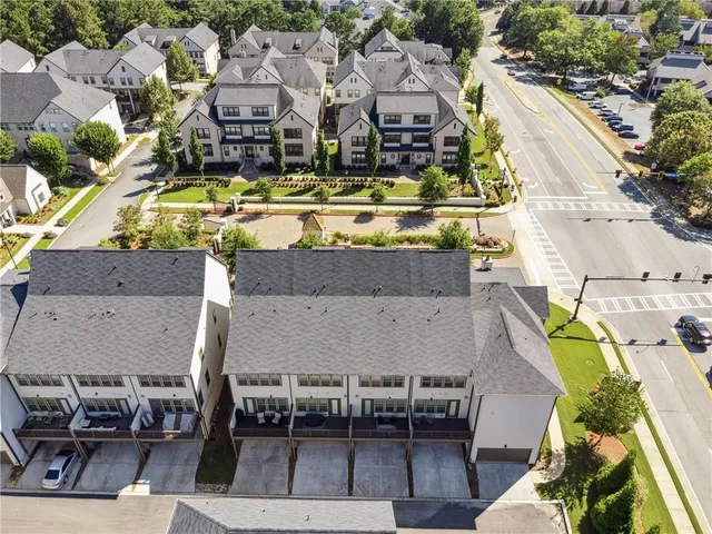 an aerial view of a swimming pool with outdoor seating