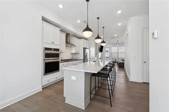 a kitchen with stainless steel appliances kitchen island a sink and a refrigerator