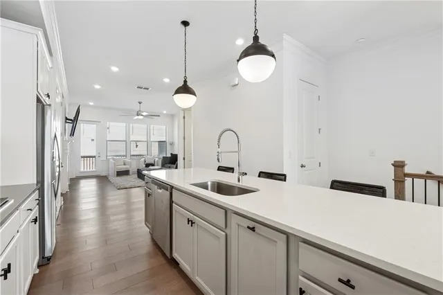 a kitchen with a sink appliances and cabinets