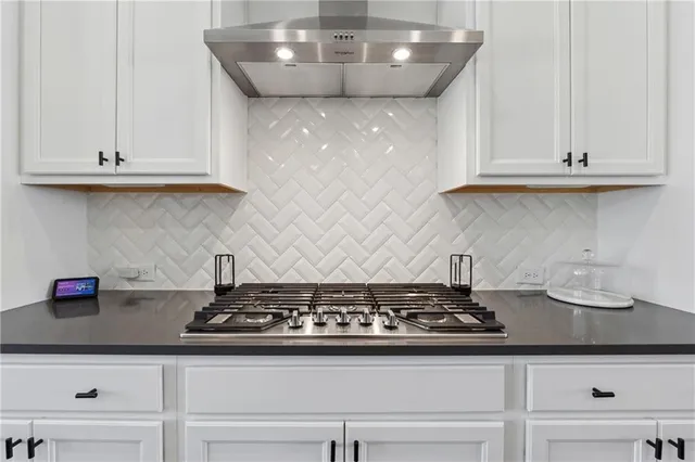 a stove top oven sitting inside of a kitchen