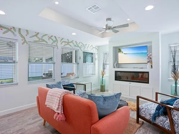a living room with furniture fireplace and flat screen tv