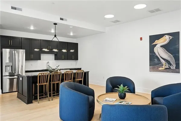 a living room with furniture kitchen and a large window