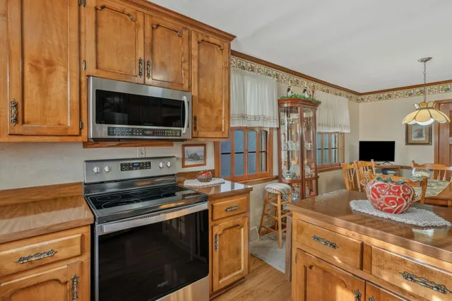 a kitchen with stainless steel appliances a stove microwave and cabinets
