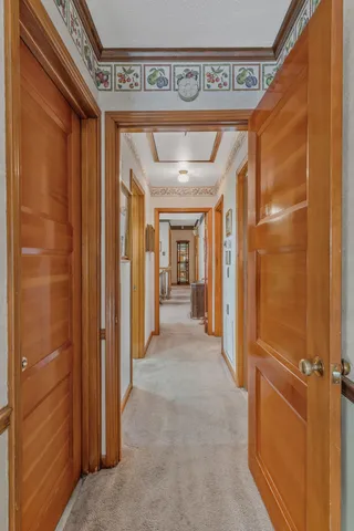 a view of a hallway with wooden shelves