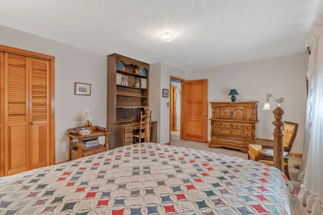 a bedroom with a bed and chair