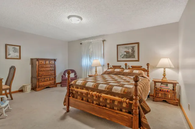 a bedroom with a bed a desk and chair