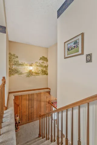 a view of a balcony with wooden floor and chair