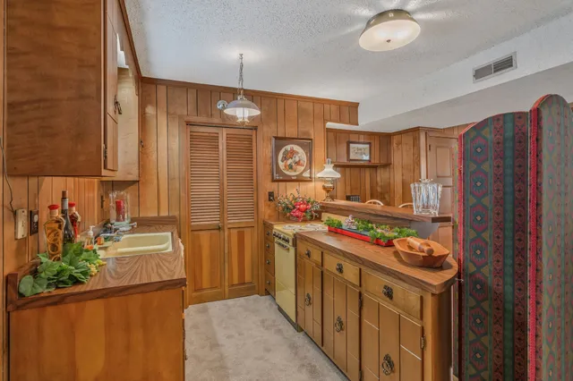 a kitchen with stainless steel appliances granite countertop a refrigerator and a stove