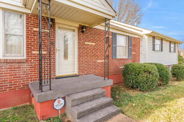 a view of a backyard with table and chairs and potted plants