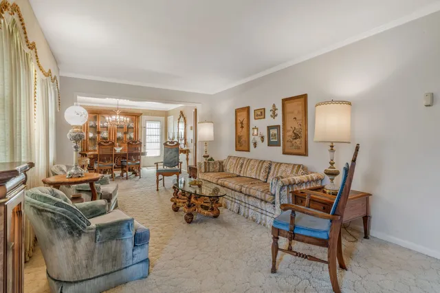 a living room with furniture and a lamp