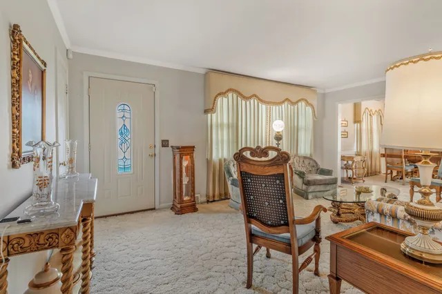 a living room with furniture a window and a lamp