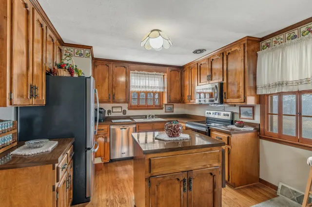 a kitchen with a stove a sink and a refrigerator