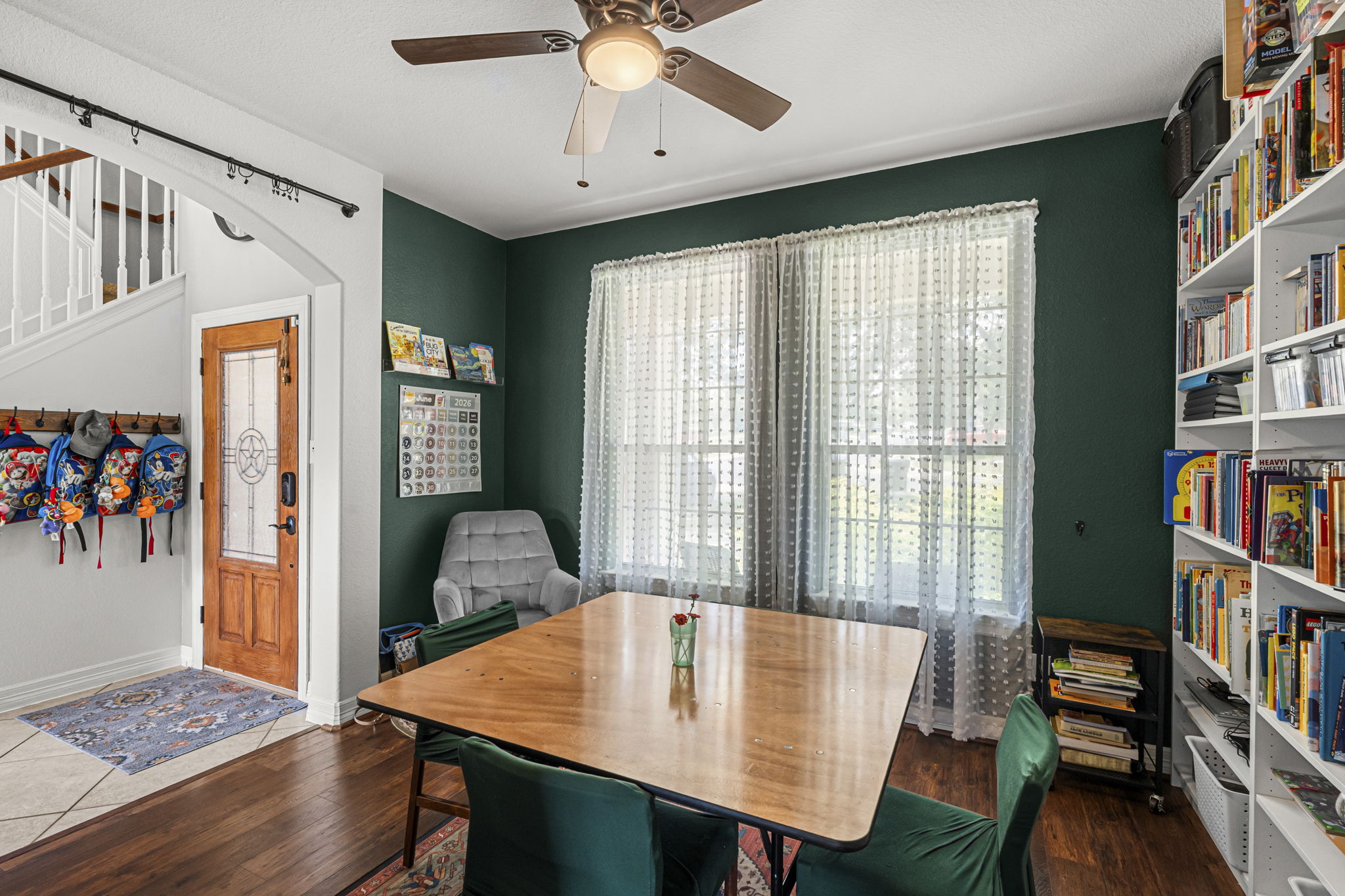 454 Fall Circle Kyle, TX 78640 - Photo 5 of 39 A well-lit interior offers a versatile space, ideal for dining or a dedicated study area with ample built-in storage.