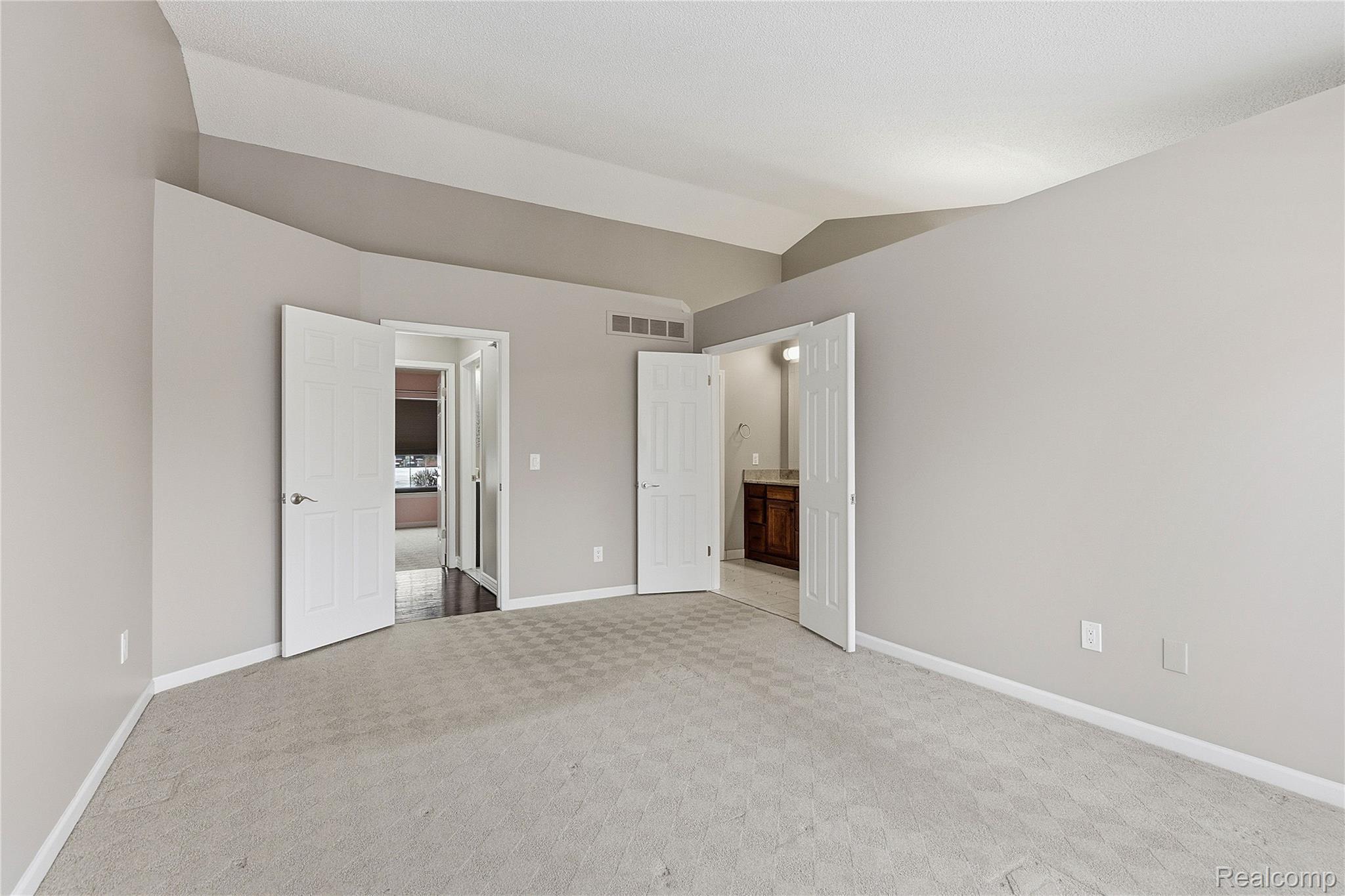 7154 Westchester Road West Bloomfield, MI 48322 - Photo 26 of 38 Unfurnished bedroom with vaulted ceiling, carpet flooring, and connected bathroom