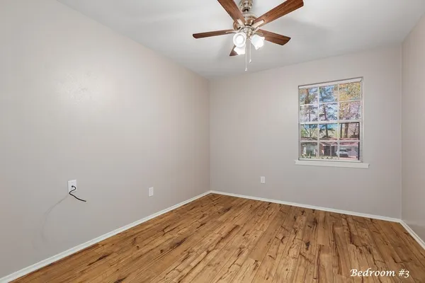 a view of a livingroom with a ceiling fan and window