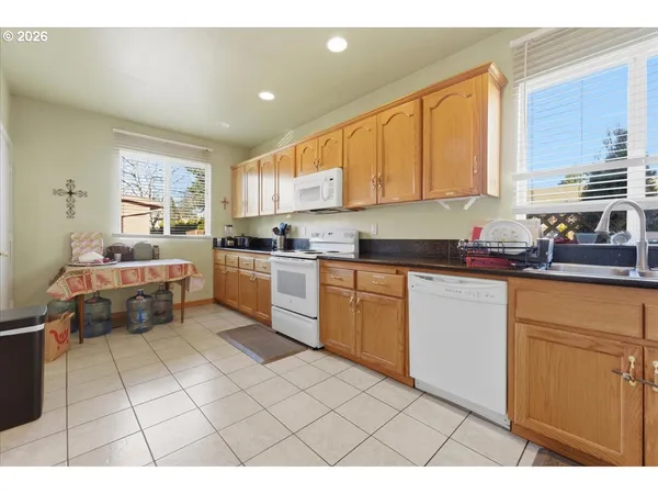 a kitchen with a refrigerator a sink dishwasher and cabinets