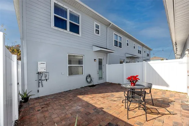 a front view of a house with a big yard and potted plants