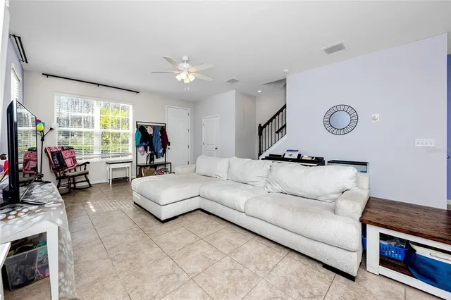 a living room with furniture gym equipment and a large window