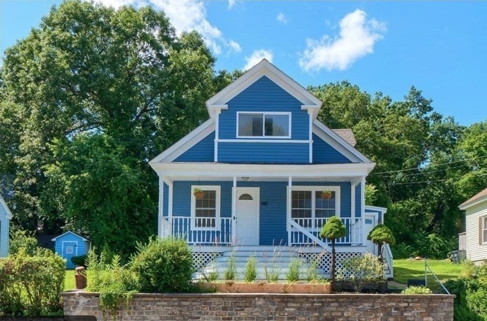 142 East Meadow Road Lowell, MA 01854 - Photo 1 of 28 a front view of a house with garden
