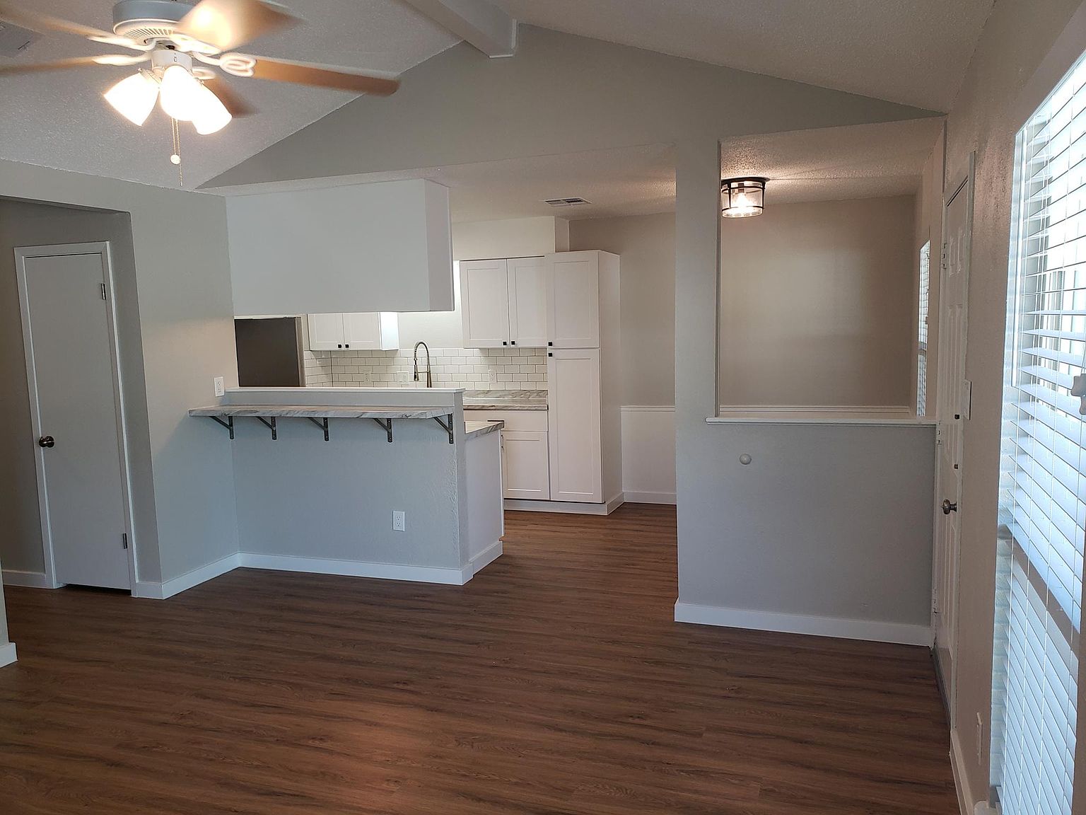 802 Ranch Road, Unit A Georgetown, TX 78628 - Photo 2 of 11 An open concept living area transitions seamlessly to a well-appointed kitchen with breakfast bar.