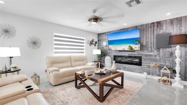 a living room with furniture a fireplace and a window