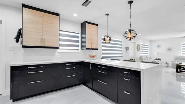 a kitchen with a sink cabinets and window