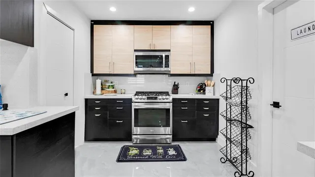 a kitchen with a sink cabinets and stainless steel appliances