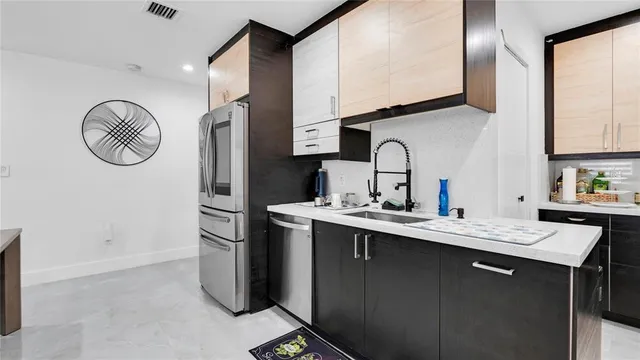 a kitchen with stainless steel appliances granite countertop a refrigerator and a stove top oven