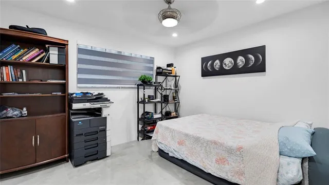 a bedroom with a bed and a wall painting