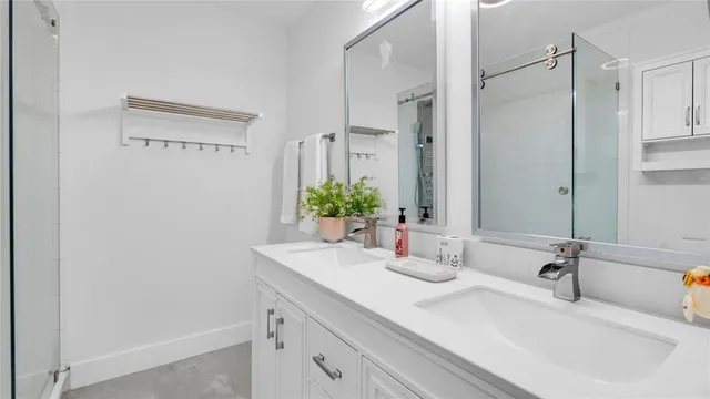 a bathroom with a glass shower door