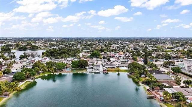 an aerial view of a swimming pool with outdoor seating yard and mountain view in back
