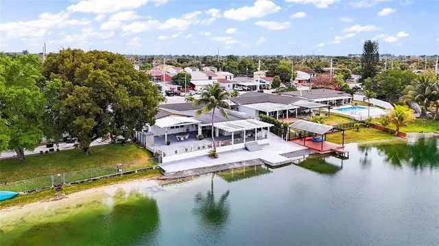 an aerial view of residential houses with outdoor space and swimming pool