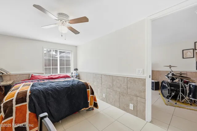 a view of a room with wooden floor table and chairs