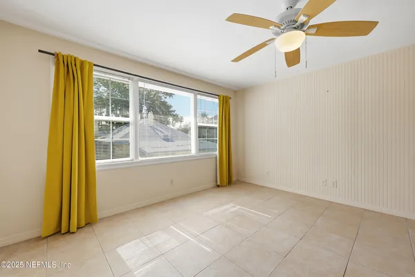 an aerial view of residential houses with outdoor space and trees
