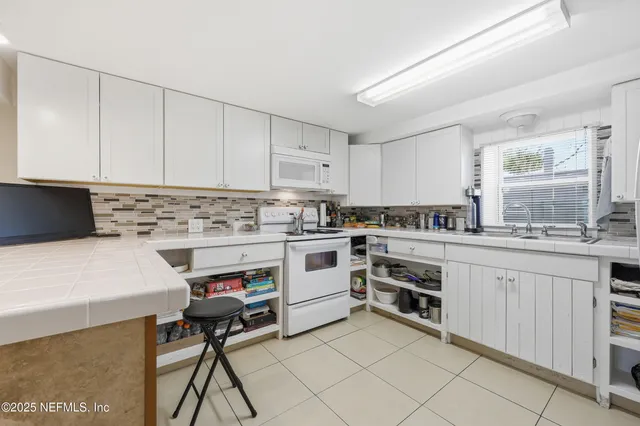 an empty room with closet and a ceiling fan