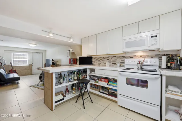 a kitchen with white cabinets and white appliances