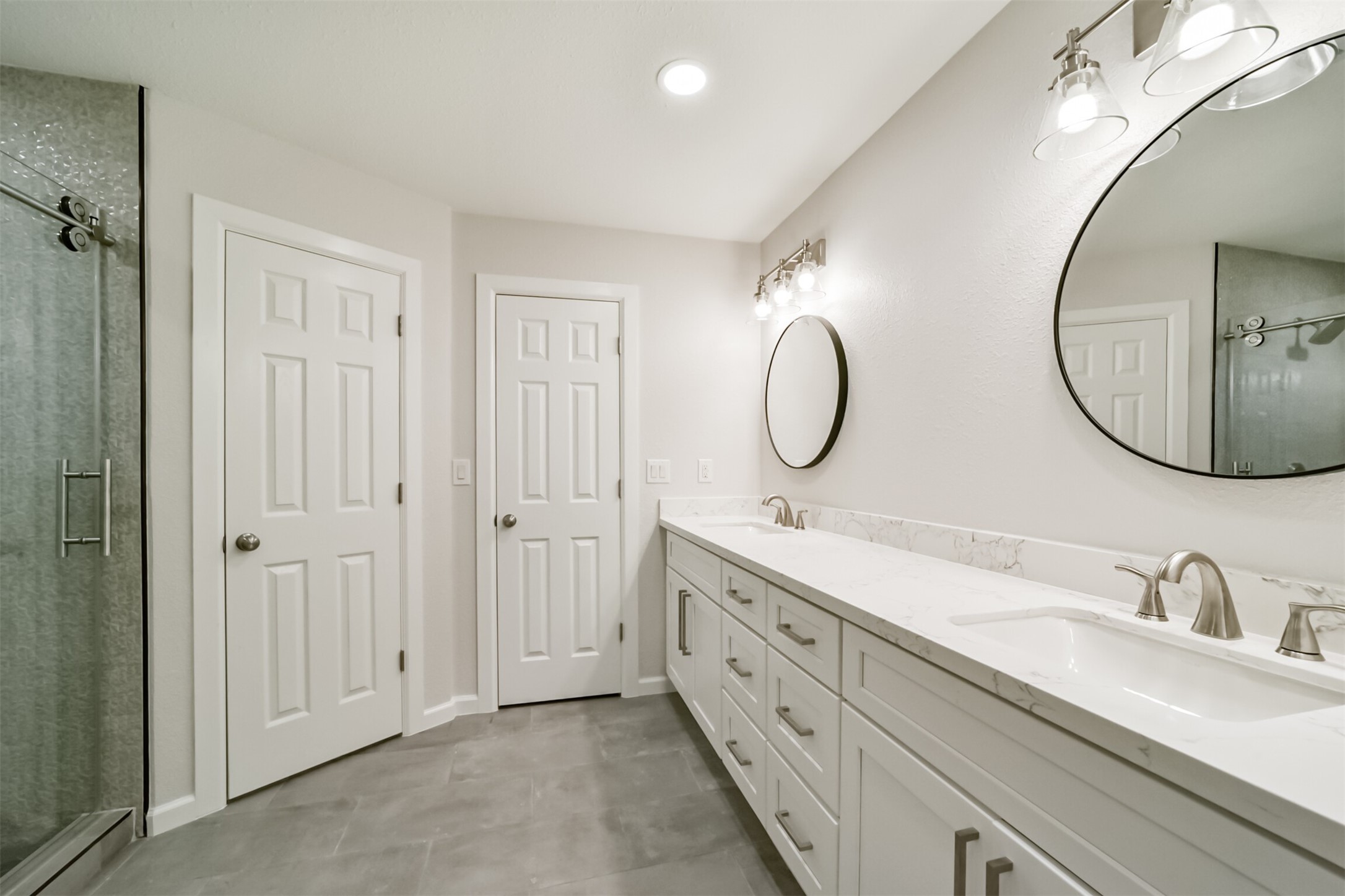 15610 Ripplewind Lane Houston, TX 77068 - Photo 22 of 44 a bathroom with a double vanity sink double and a mirror