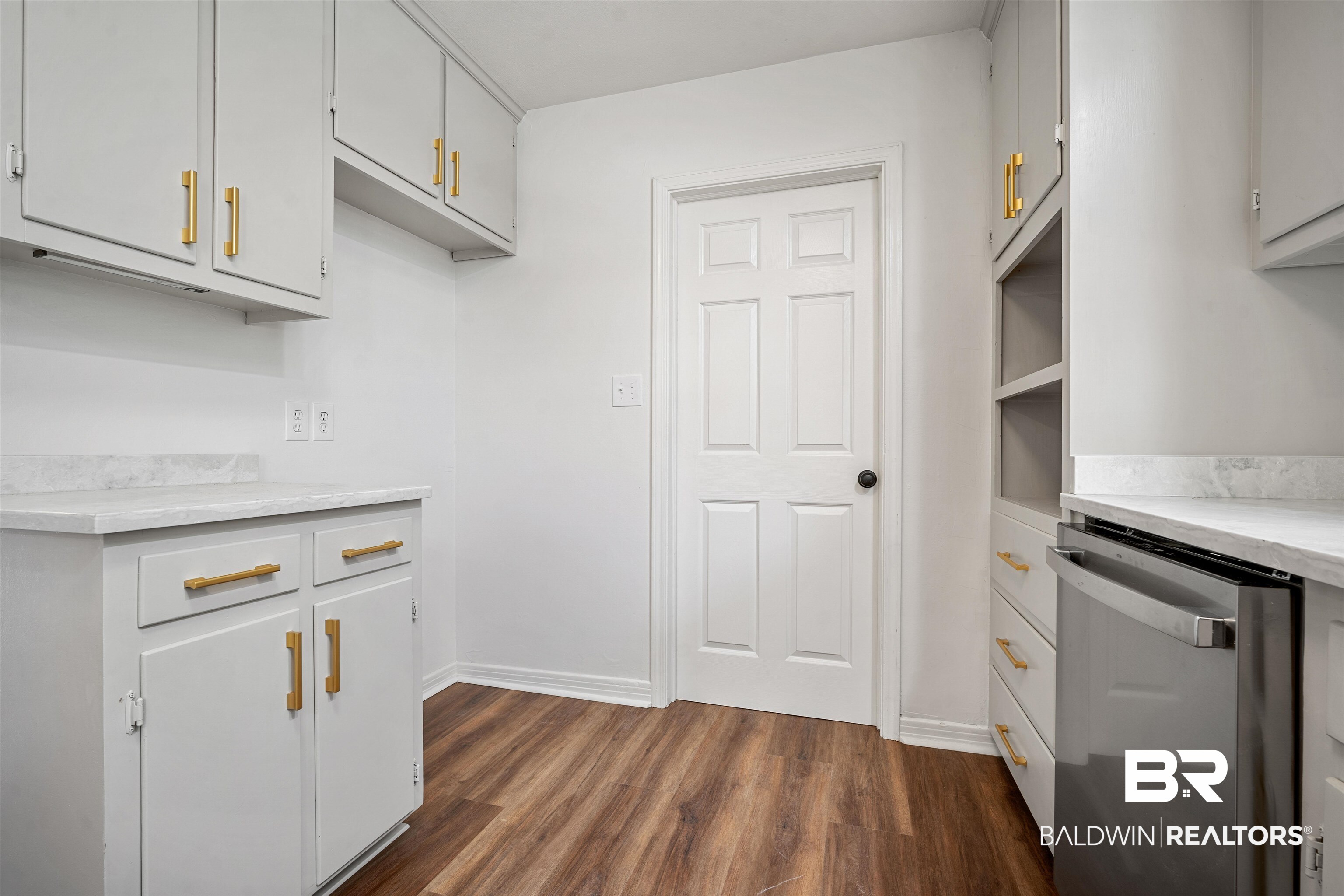 860 Montfort Road South Mobile, AL 36608 - Photo 9 of 27 Kitchen with stainless steel dishwasher, dark wood finished floors, and white cabinets