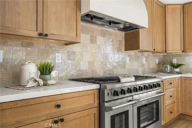 a kitchen with stainless steel appliances granite countertop a sink a stove and refrigerator