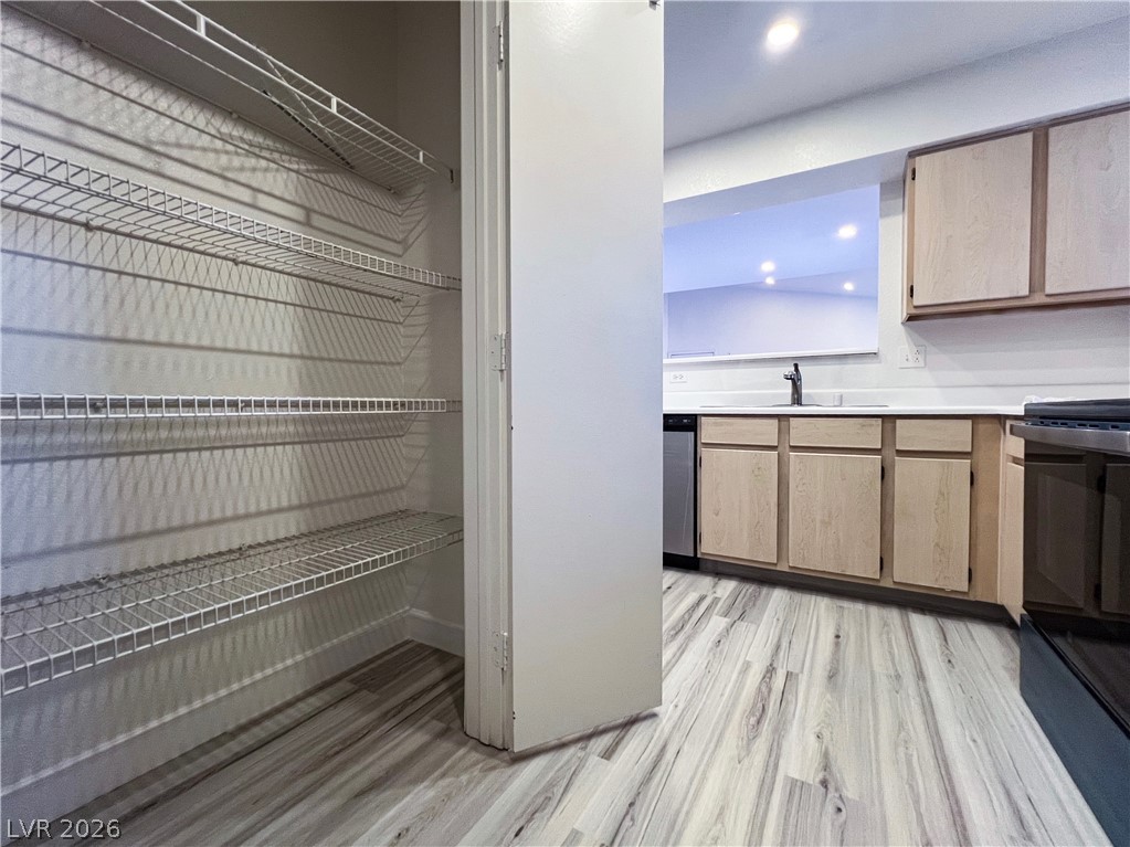 8101 West Flamingo Road, Unit 2129 Las Vegas, NV 89147 - Photo 3 of 12 Well-organized pantry storage and a practical kitchen area define this home's efficient culinary space.