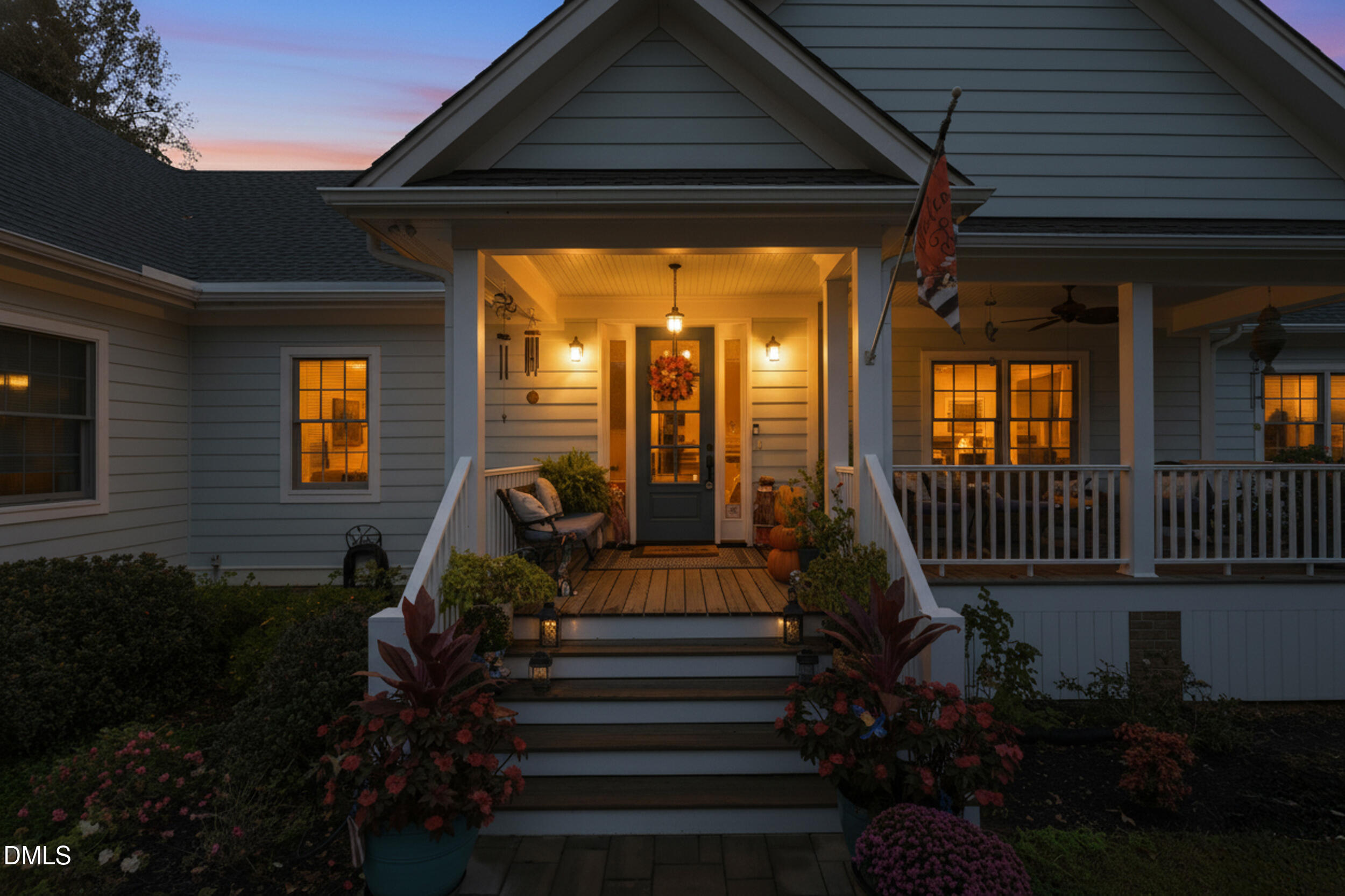 7528 McBane Mill Road Graham, NC 27253 - Photo 2 of 46 a view of a house with large windows and a flower garden