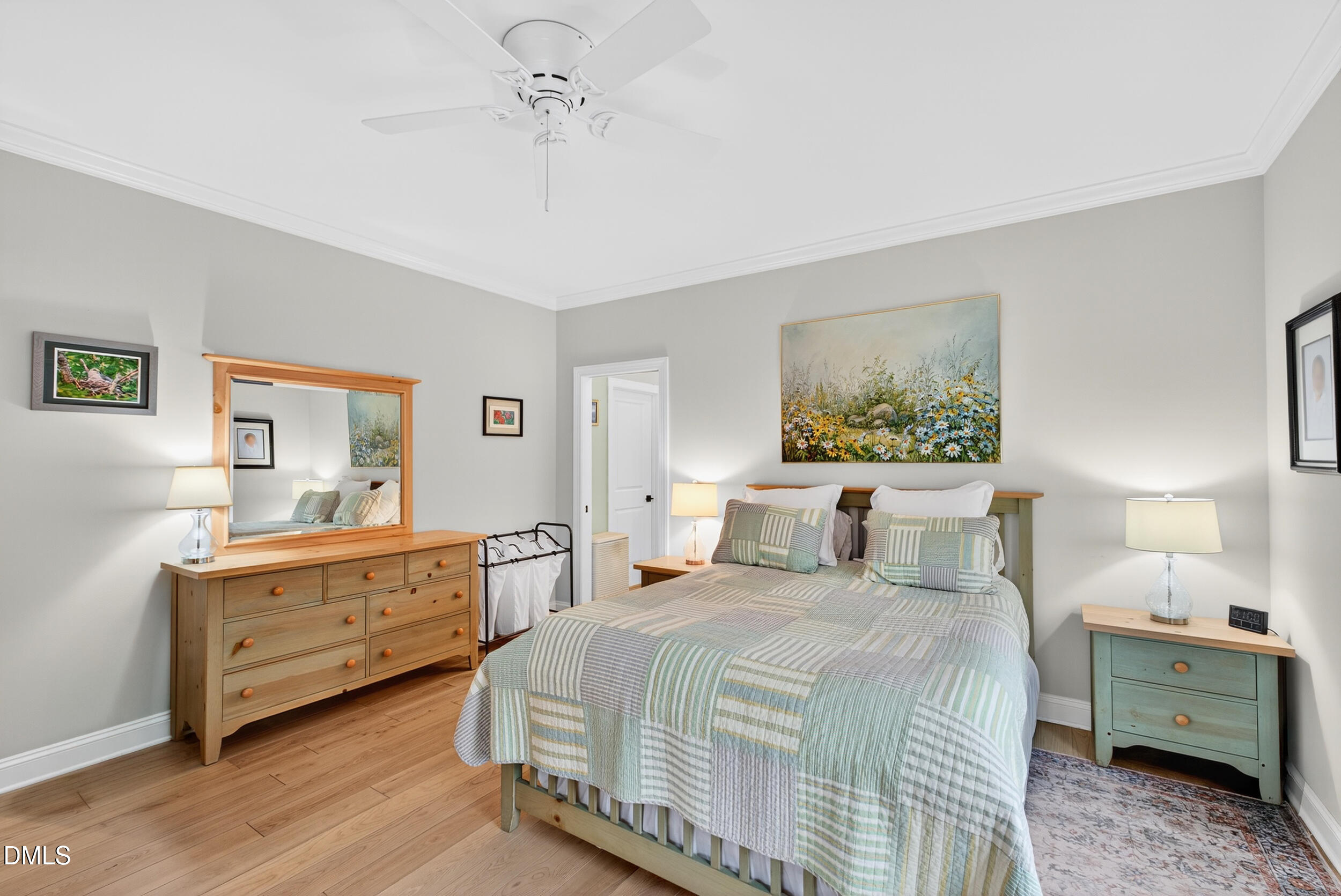 7528 McBane Mill Road Graham, NC 27253 - Photo 28 of 46 a large bedroom with a bed and a chandelier