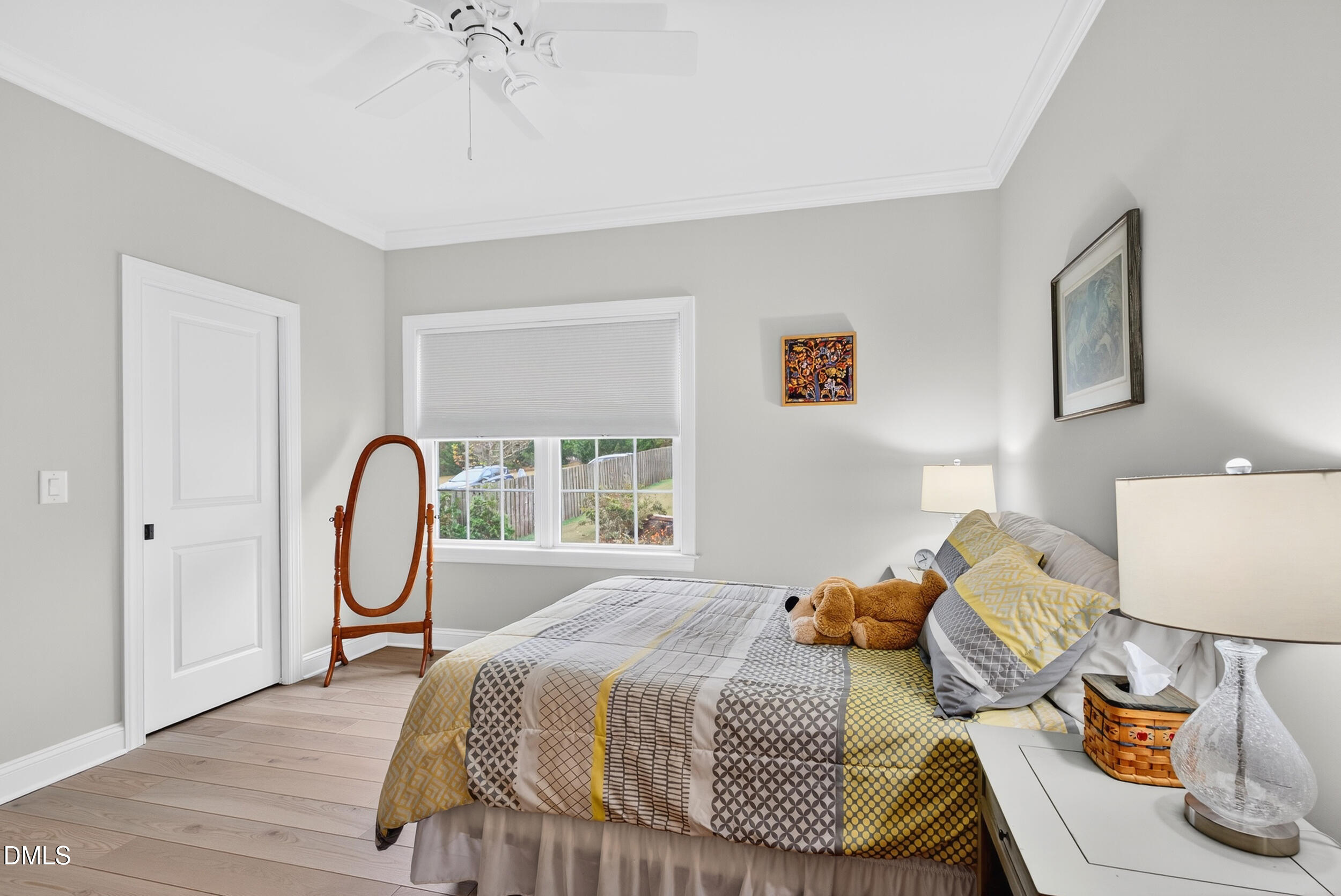 7528 McBane Mill Road Graham, NC 27253 - Photo 34 of 46 a bedroom with a bed and a chandelier