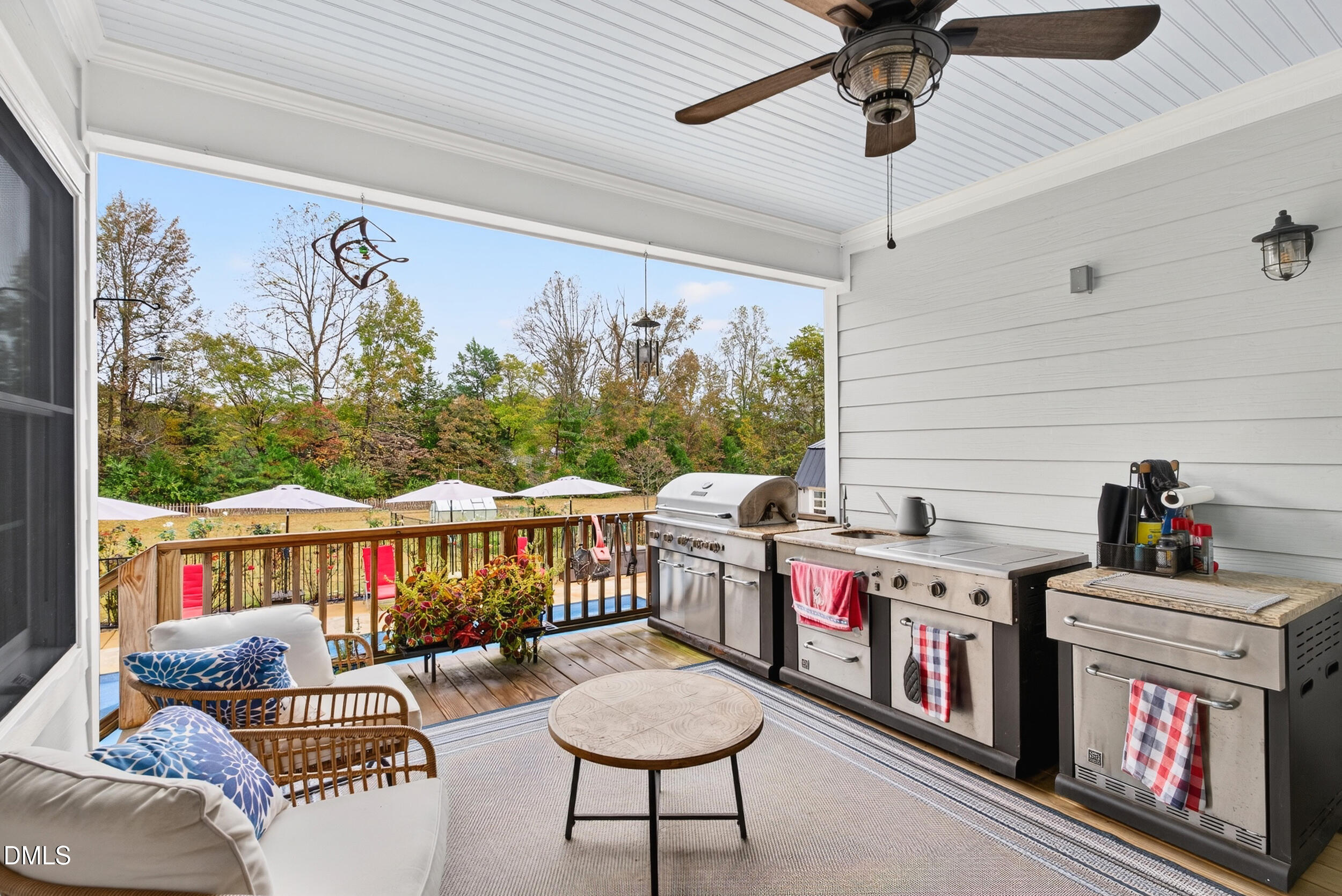 7528 McBane Mill Road Graham, NC 27253 - Photo 37 of 46 a living room with furniture a flat screen tv and a floor to ceiling window