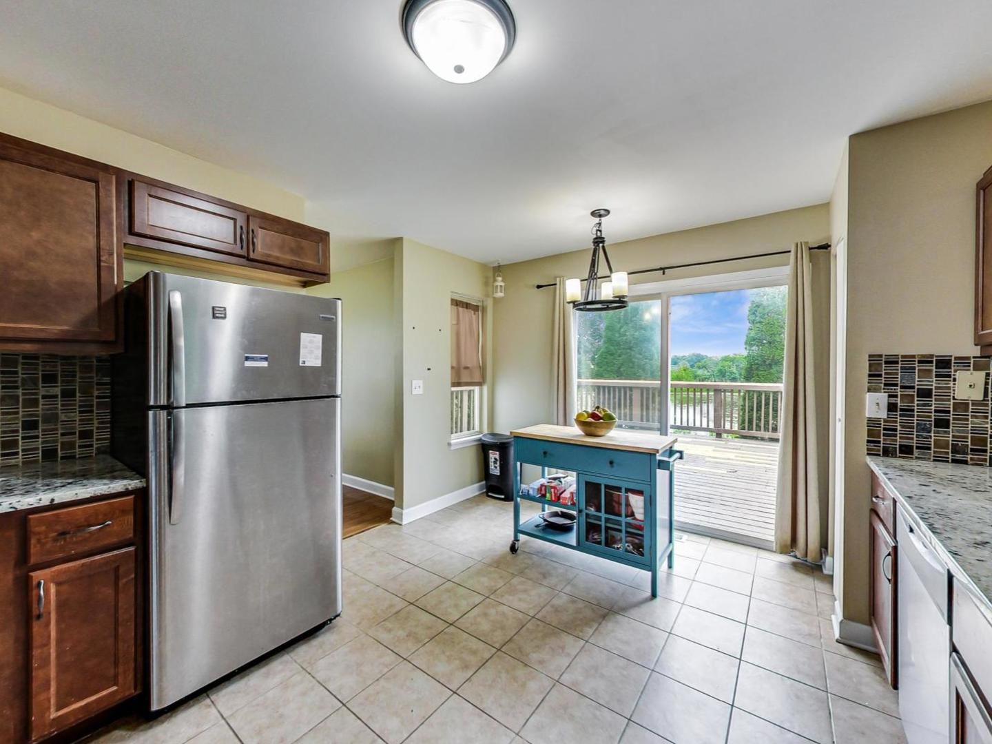 2385 North Periwinkle Way Round Lake Beach, IL 60073 - Photo 14 of 51 a kitchen with stainless steel appliances granite countertop a refrigerator and a stove top oven