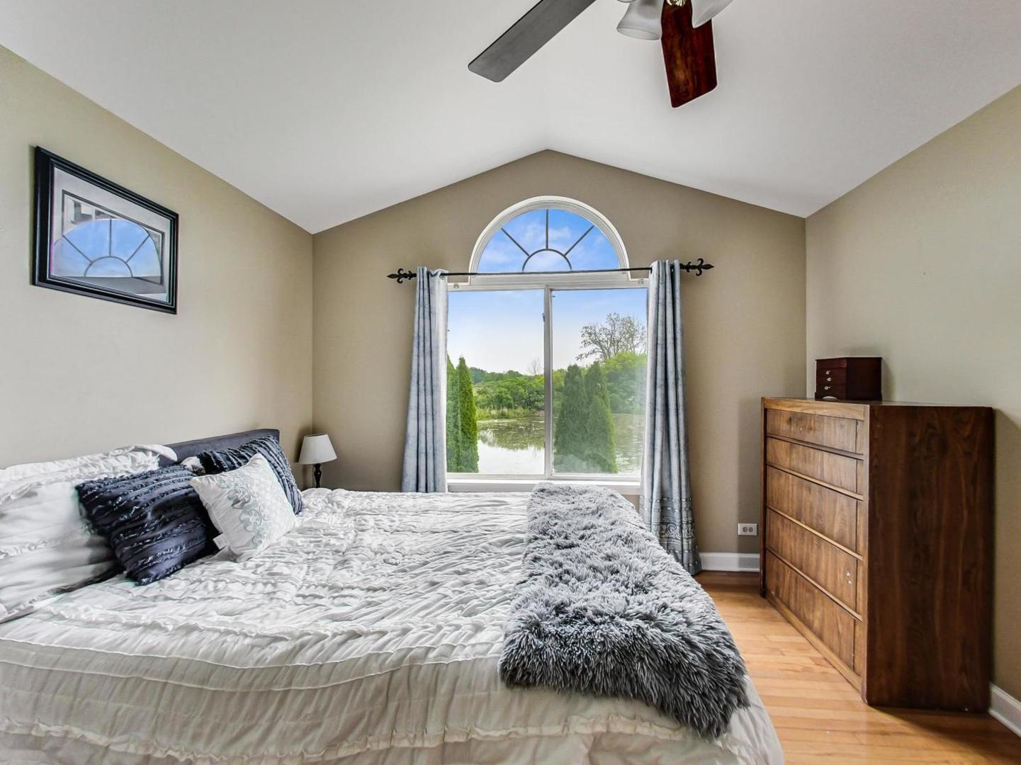 2385 North Periwinkle Way Round Lake Beach, IL 60073 - Photo 21 of 51 a bed sitting in a bedroom next to a window