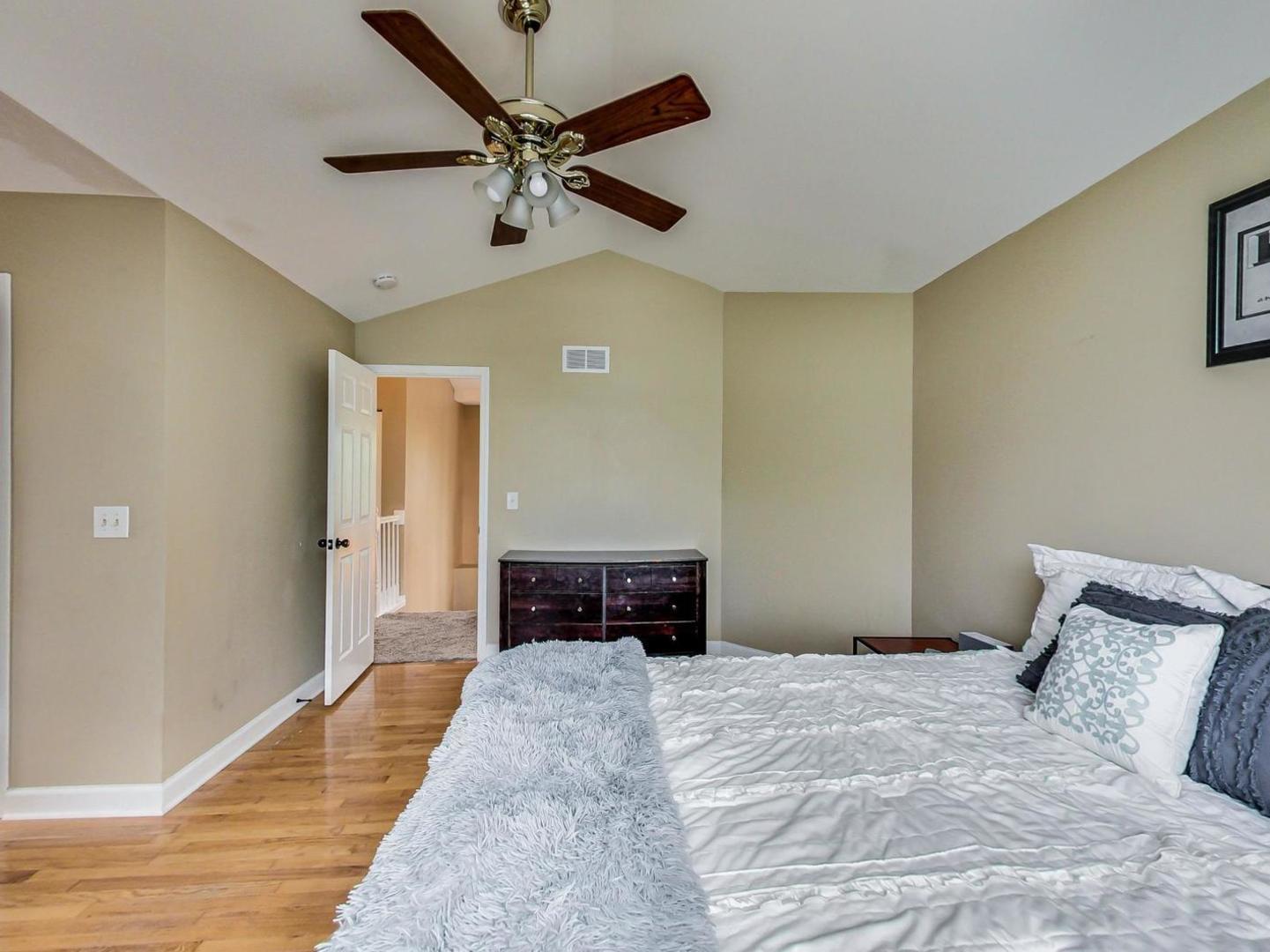 2385 North Periwinkle Way Round Lake Beach, IL 60073 - Photo 23 of 51 a bedroom with a bed and a chandelier
